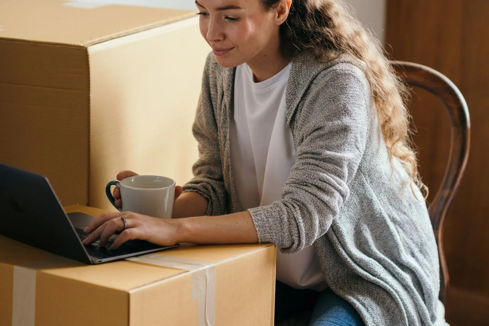 Woman looking up a moving company on her laptop